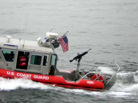 1995 Ford Bronco - A U.S. Coast Guard boat is seen underway, equipped with a machine gun and flying the American flag.
