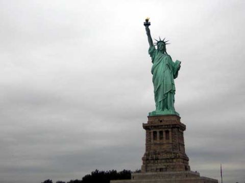 1995 Ford Bronco - The Statue of Liberty stands tall, a symbol of freedom against an overcast sky.