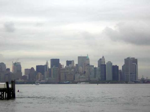 1995 Ford Bronco - A view of the New York City skyline under a cloudy sky, with a body of water in the foreground.