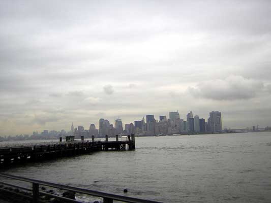 New York City skyline across water with a pier