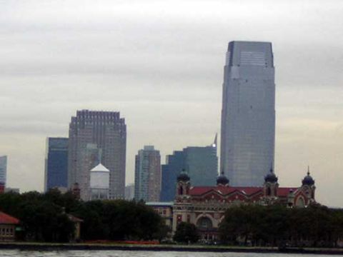 1995 Ford Bronco - View of the New York City skyline and historic Ellis Island buildings under an overcast sky.