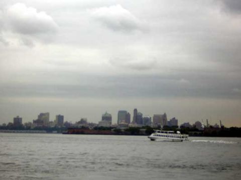 1995 Ford Bronco - A ferry boat travels across the water with the New York City skyline visible on the horizon.