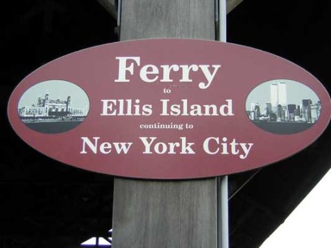 1995 Ford Bronco - A sign indicates ferry routes to Ellis Island and New York City, illustrations of both locations.