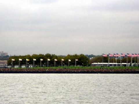 1995 Ford Bronco - Waterfront scene with numerous flags displayed along a promenade with buildings in the distance.