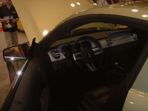 1999 Ford Crown Victoria - Interior view of a light green car, likely a Ford Mustang, at an auto show.