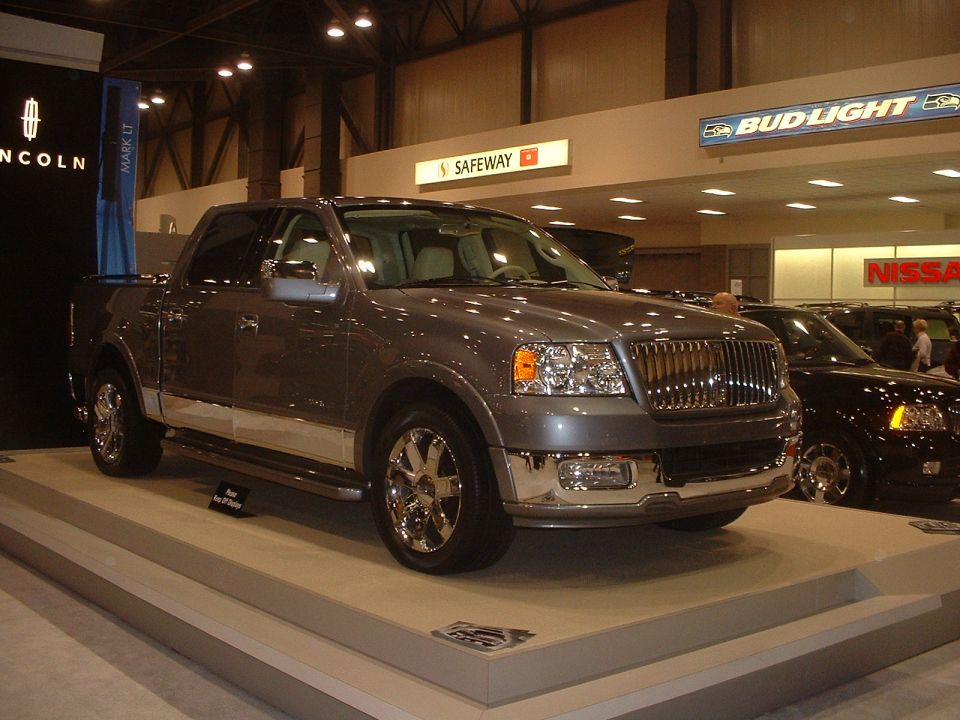 Gray Lincoln Mark LT pickup truck with chrome grille and wheels, displayed indoors