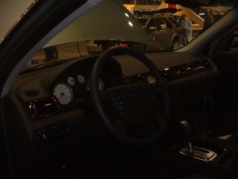 1999 Ford Crown Victoria - The interior of a car is shown, with another vehicle visible in the background at what appears to be a car show.