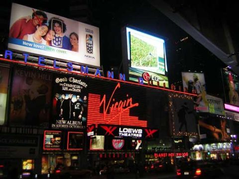1995 Ford Bronco - A nighttime view of Times Square, illuminated by numerous bright billboards and advertisements.