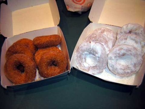 1995 Ford Bronco - Two boxes of donuts, one with cinnamon sugar and one with powdered sugar, sit on a dark surface.