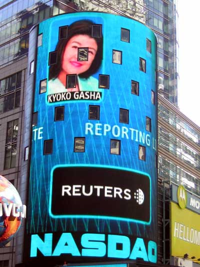 1995 Ford Bronco - A large digital billboard in Times Square shows a news reporter and the Reuters logo.