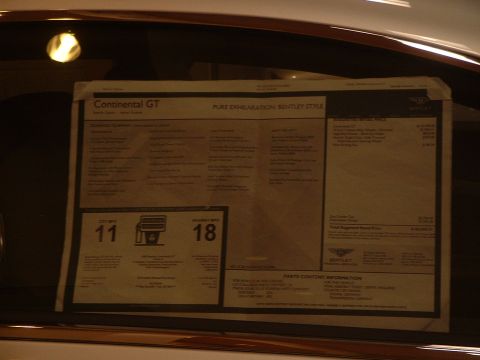 1999 Ford Crown Victoria - A window sticker for a Bentley Continental GT is displayed on a car window, showing pricing and fuel economy details.