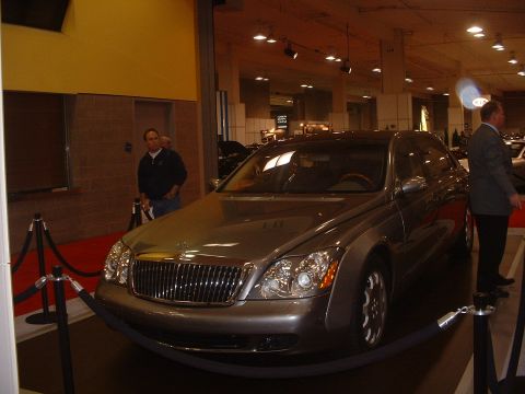 1999 Ford Crown Victoria - A Maybach 57 sedan is displayed indoors at an auto show.