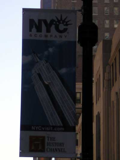 1995 Ford Bronco - A banner for NYC & Company, displaying the Empire State Building and The History Channel logo, hangs from a lamppost.