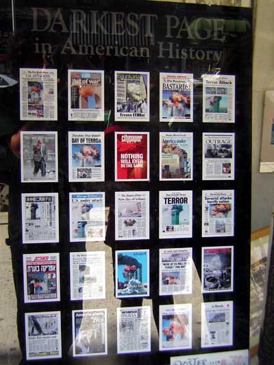 1995 Ford Bronco - A display of newspapers and magazines, many with headlines about the 9/11 attacks, is shown in a window.
