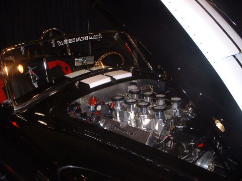 1999 Ford Crown Victoria - Close-up of a custom V8 engine with eight carburetors and "Park Place Racing" decal.
