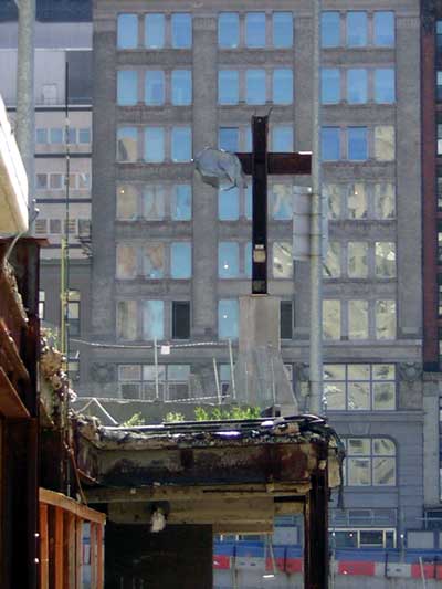 1995 Ford Bronco - A large cross stands against a backdrop of urban architecture.