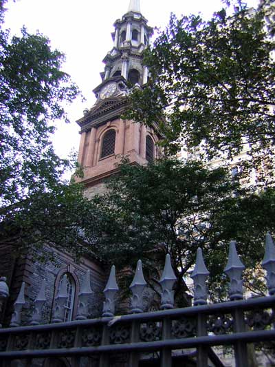 1995 Ford Bronco - A church tower with a clock is seen behind trees and a decorative fence.