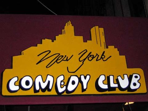 1995 Ford Bronco - A sign for a comedy club in New York City is displayed.