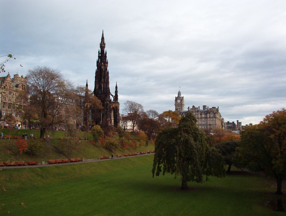 Scott Monument and Balmoral clock tower seen across Princes Street Gardens in autumn