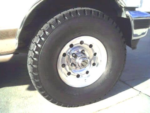 1995 Ford Bronco - Close-up view of a vehicle's wheel and tire assembly.