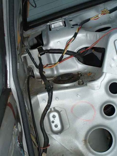 1986 Toyota Corolla - Close-up of the car's internal wiring system, revealing exposed metal and electrical components.