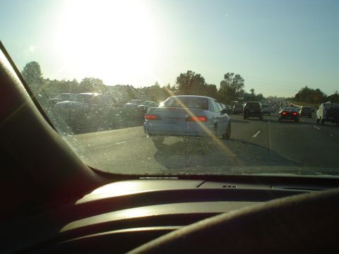 1993 Ford Taurus - Driving in heavy traffic on a clear, sunny day. The sun is bright and glares off the windshield.