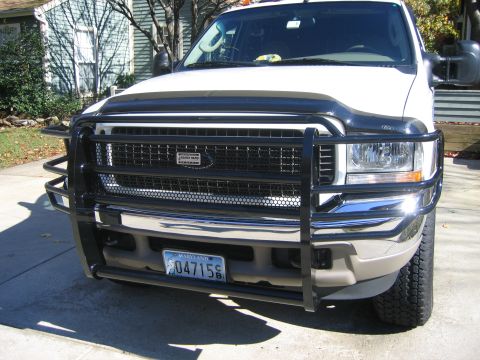 2003 Ford Excursion - A white Ford Excursion is shown from the front, equipped with a heavy-duty black grille guard and a Maryland license plate.