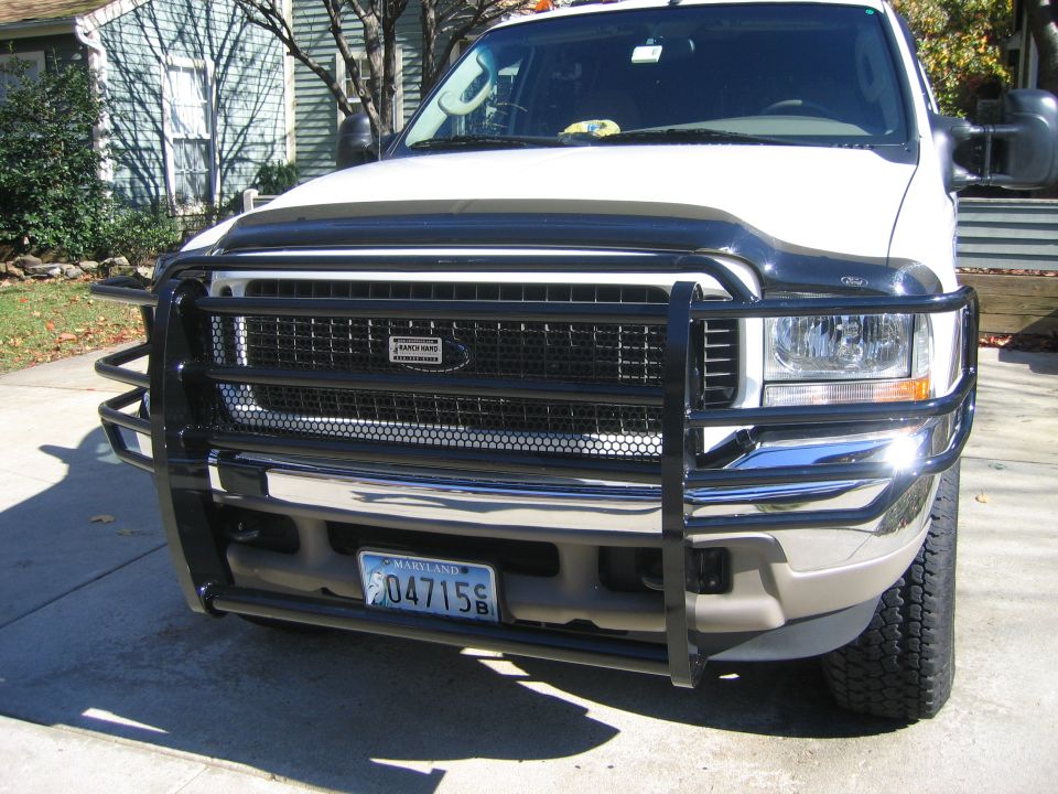 White Ford Excursion front end with black Ranch Hand grille guard and hood deflector