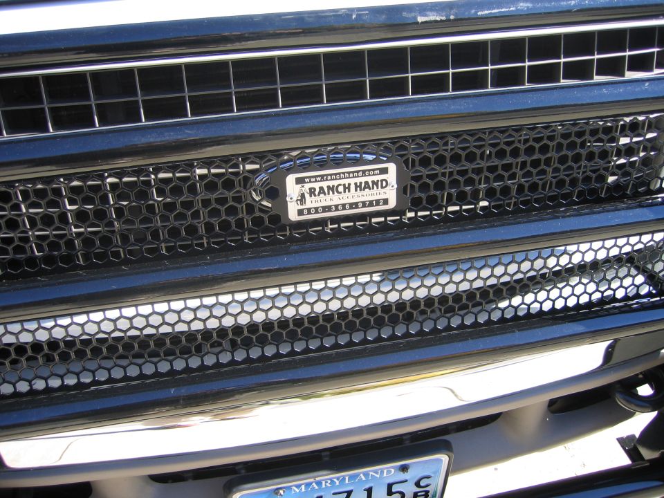Black honeycomb grille inserts with Ranch Hand badge on a dark blue truck