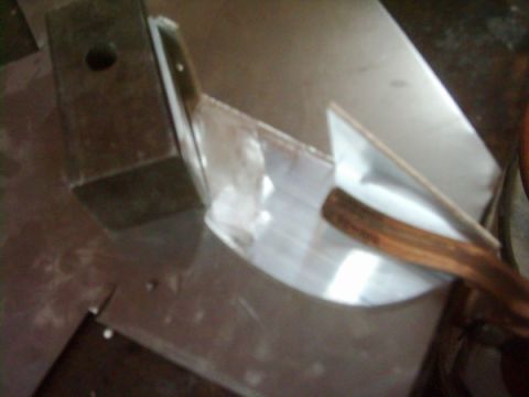 1978 Ford Bronco - A metal bracket and wooden handle are shown in this close-up view.