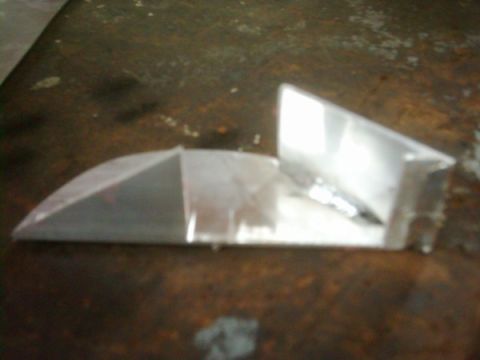1978 Ford Bronco - Clear plastic automotive part on a workbench.