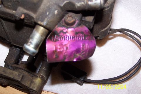 1979 Ford Bronco - A close-up view of a Motorcraft carburetor tag, showing stamped identification numbers.