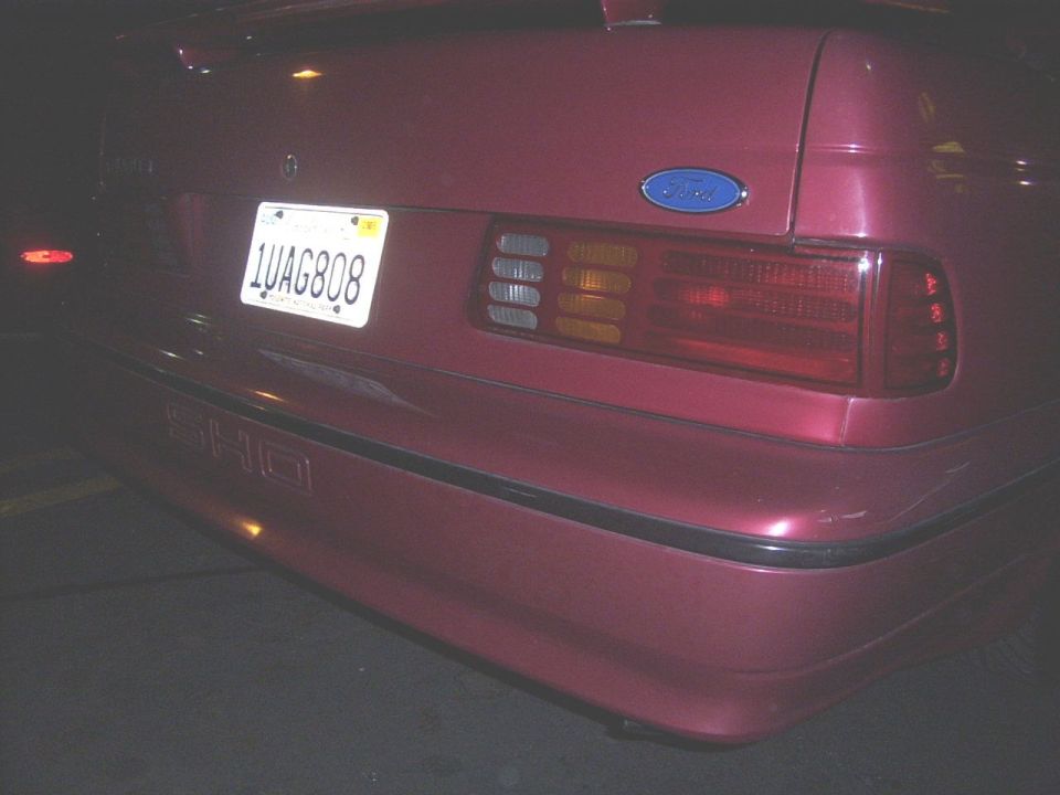 Red car rear with SHO badge and license plate 1UAG808
