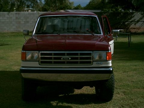 1988 Ford Bronco - Front view of a red and white Ford truck, likely a 1987 model based on the grille design.