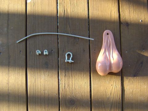 1993 Ford Bronco - Truck nuts accessory and mounting hardware laid out on a wooden deck.