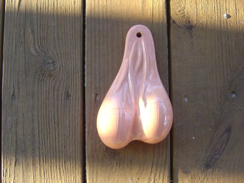 1993 Ford Bronco - A pair of pink truck nuts are displayed against a background of weathered wooden planks.