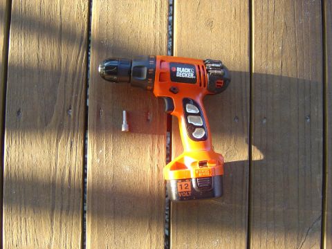 1993 Ford Bronco - A 12-volt Black & Decker drill and a bit rest on a wooden surface.