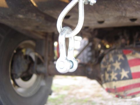 1993 Ford Bronco - Vehicle undercarriage with a shackle and a differential cover decorated with the American flag.
