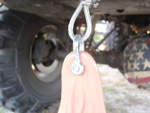 1993 Ford Bronco - Undercarriage view shows a tow strap attached to the frame, with a tire and a flag-themed differential cover.