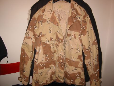 1979 Chevrolet Caprice - A desert camouflage jacket is displayed, showing its front view with several pockets and a button-up closure.