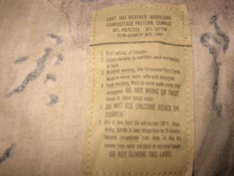 1979 Chevrolet Caprice - Label details washing instructions for a woodland camouflage pattern combat coat, including material composition and care guidelines.