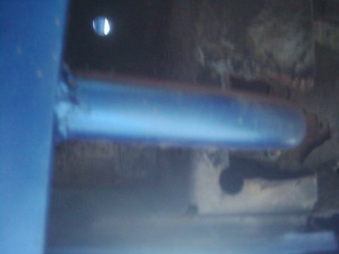 1978 Ford Bronco - A close-up view of a blue cylindrical object, possibly a pipe or tube, with a bright light source visible above it.