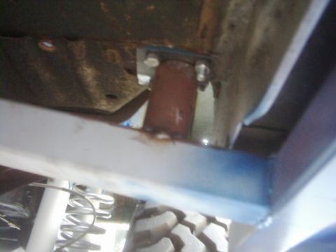 1978 Ford Bronco - Close-up view of a vehicle's undercarriage, showing suspension parts and frame elements.