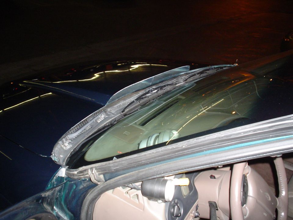 Windshield wipers on a dark car interior with SuperMotors logo visible