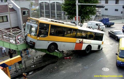 1996 Ford Bronco - A bus has crashed onto a pedestrian overpass, causing significant damage to the front of the vehicle.