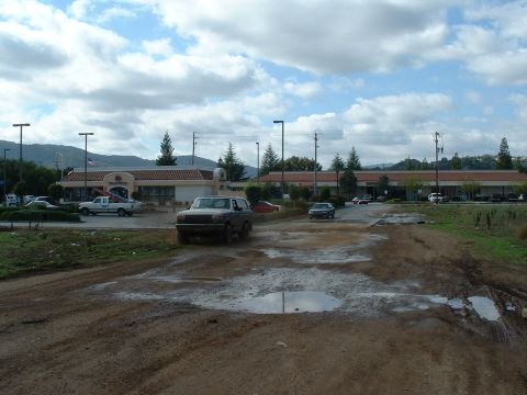 1990 Ford Bronco - This 1990 Ford Bronco navigates a muddy, puddle-filled path in front of a commercial building.
