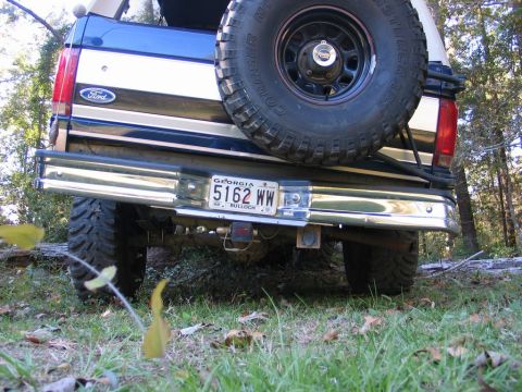 1995 Ford Bronco - The rear of a blue and white Ford Bronco is shown with a spare tire and a Georgia license plate.