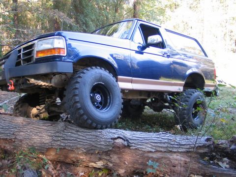 1995 Ford Bronco - This lifted 1995 Ford Bronco navigates an obstacle on a wooded trail.