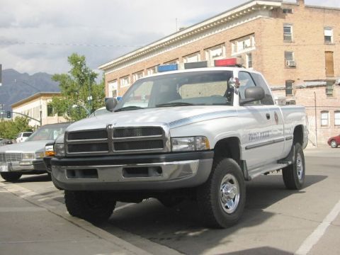 1992 Ford Crown Victoria - This Dodge Ram pickup truck was used by the Provo Police Department. A sedan is parked nearby.