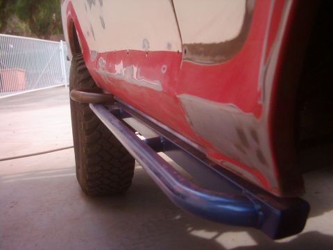 1978 Ford Bronco - The side of a vehicle shows custom rock sliders and bodywork in progress.